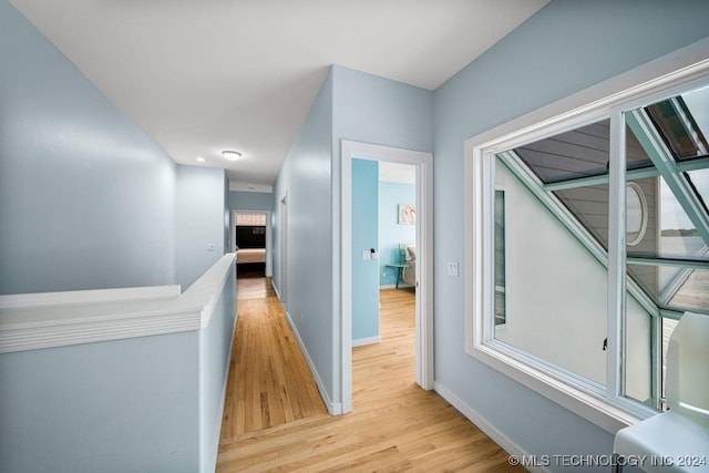 corridor with light hardwood / wood-style floors