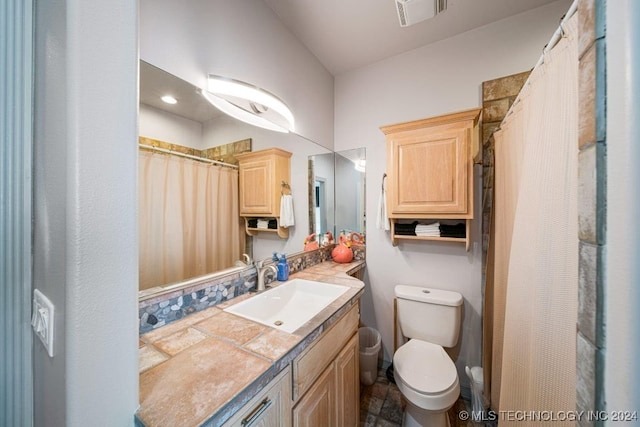 bathroom with vanity, toilet, and walk in shower