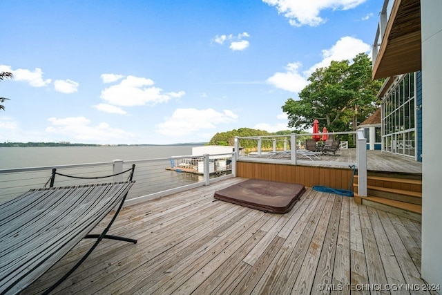 wooden deck featuring a water view