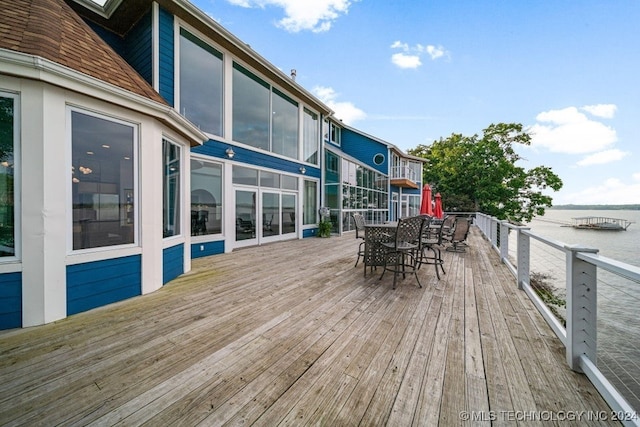 wooden terrace featuring a sunroom and a water view