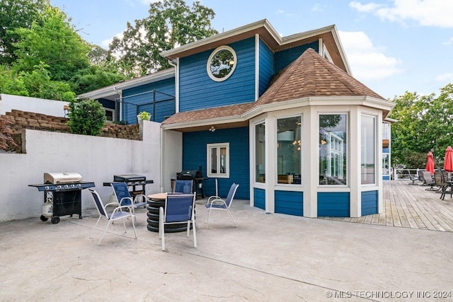 back of property with a wooden deck