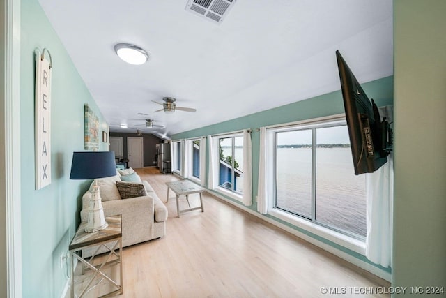 living room featuring ceiling fan and light hardwood / wood-style floors