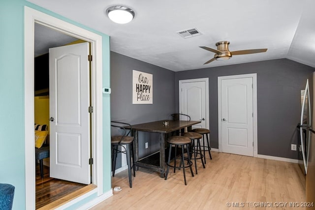 dining space featuring vaulted ceiling, light hardwood / wood-style flooring, and ceiling fan