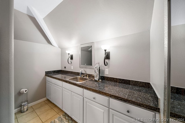 bathroom featuring vanity, tile patterned floors, and lofted ceiling