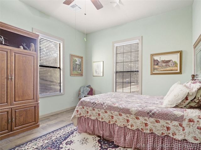 bedroom with ceiling fan and light hardwood / wood-style floors