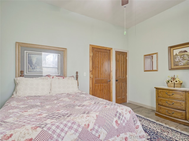 bedroom with lofted ceiling and light hardwood / wood-style flooring