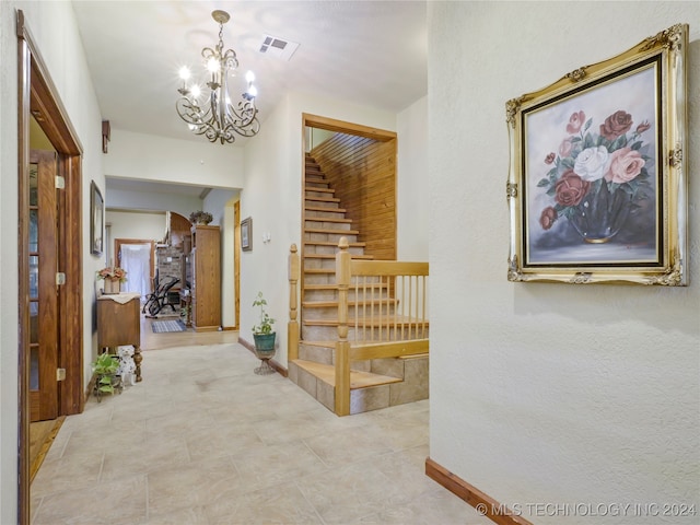 hallway with light tile patterned floors and a chandelier