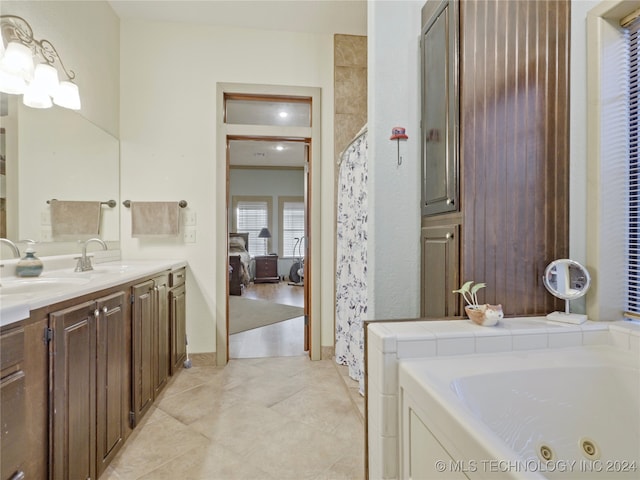 bathroom with tile patterned flooring, vanity, washer / clothes dryer, and a washtub