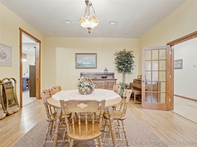 dining space featuring french doors and light hardwood / wood-style floors