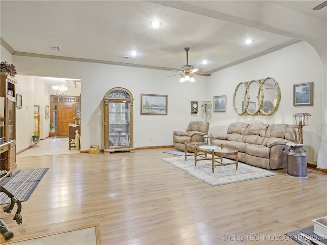 living room featuring ceiling fan with notable chandelier, light wood-type flooring, and crown molding