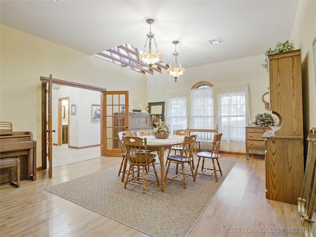 dining room featuring light hardwood / wood-style floors and a notable chandelier