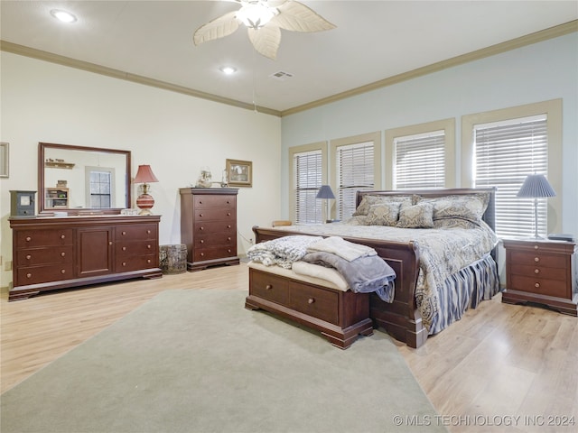 bedroom featuring ceiling fan, ornamental molding, and light hardwood / wood-style flooring