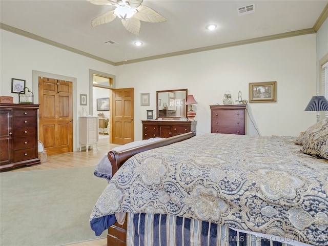 bedroom with light hardwood / wood-style flooring, ceiling fan, and ornamental molding