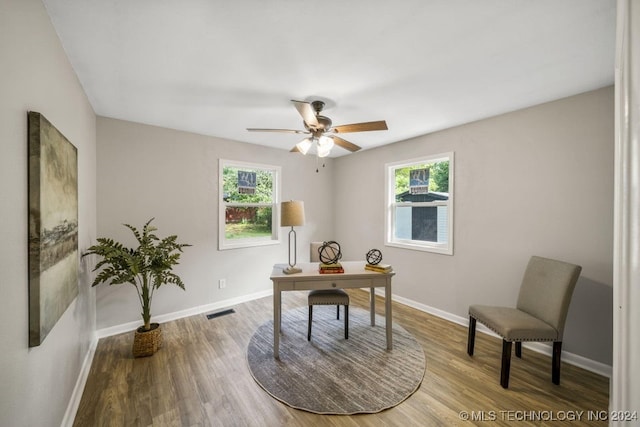 home office featuring plenty of natural light, ceiling fan, and wood-type flooring