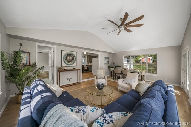 living room with hardwood / wood-style floors, vaulted ceiling, and ceiling fan