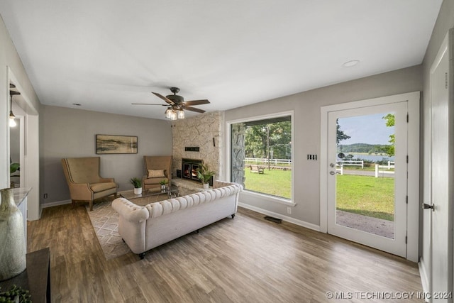 living room with ceiling fan and hardwood / wood-style flooring