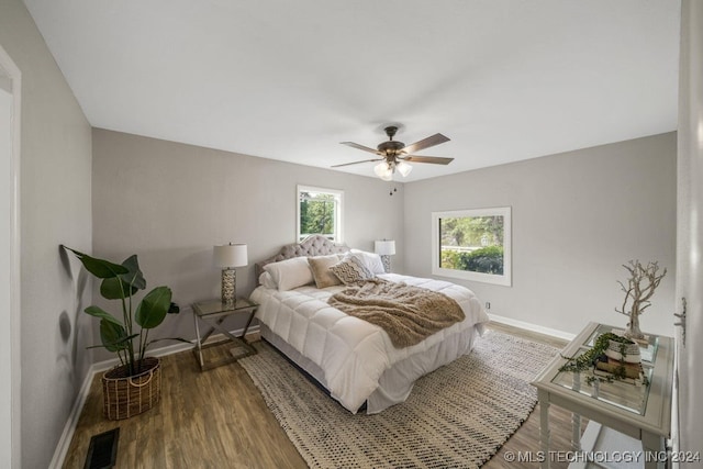 bedroom with wood-type flooring and ceiling fan