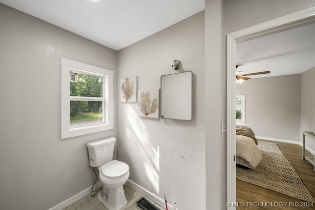 bathroom with hardwood / wood-style floors and toilet