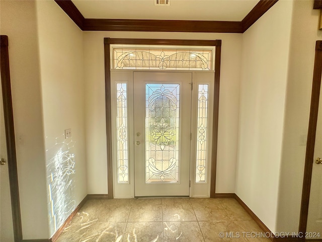 entrance foyer featuring light tile patterned floors and ornamental molding