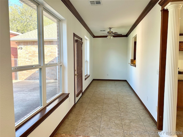 hallway with ornate columns, crown molding, and light tile patterned floors