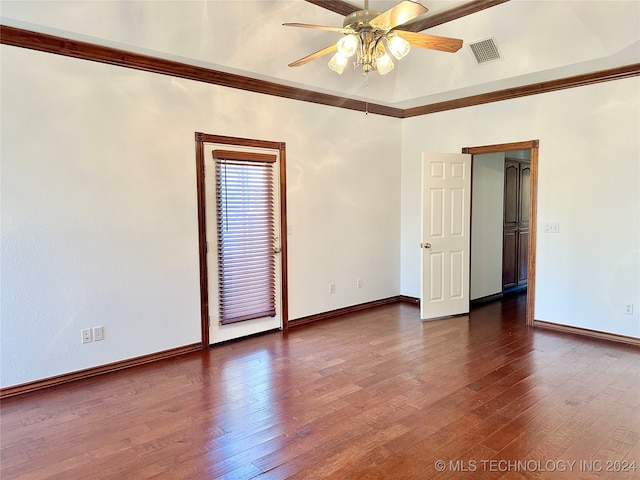 spare room with ceiling fan, crown molding, and dark wood-type flooring