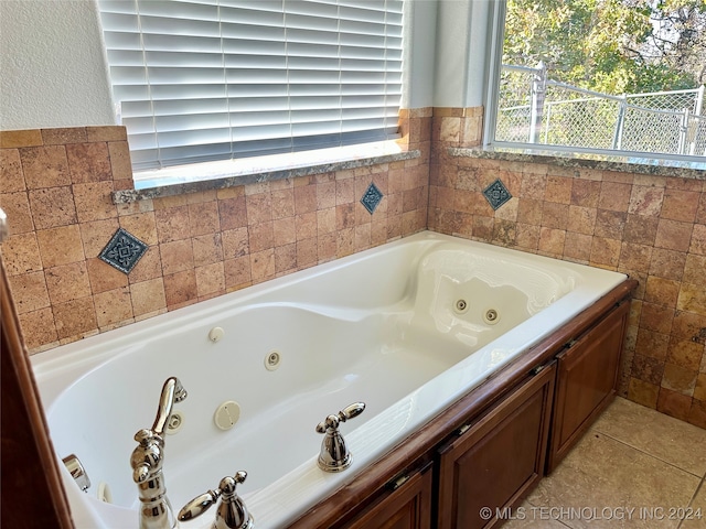 bathroom featuring tile patterned flooring and a tub