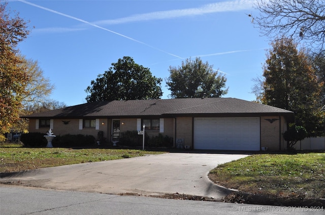 single story home with a garage and a front yard