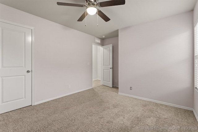 unfurnished bedroom featuring ceiling fan and light colored carpet