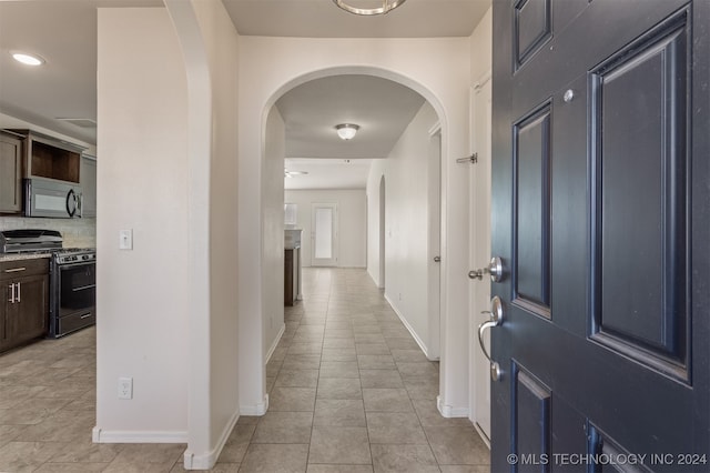 hall with light tile patterned floors