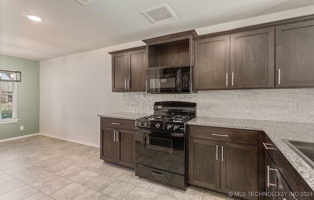 kitchen featuring black appliances, dark brown cabinets, light stone counters, and backsplash