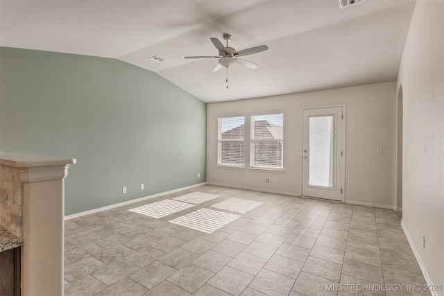 tiled empty room with vaulted ceiling and ceiling fan