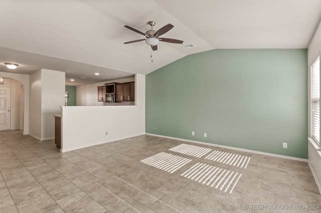 unfurnished living room with ceiling fan and lofted ceiling