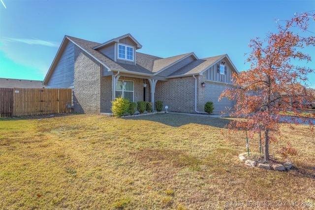 view of front of house with a front yard and a garage