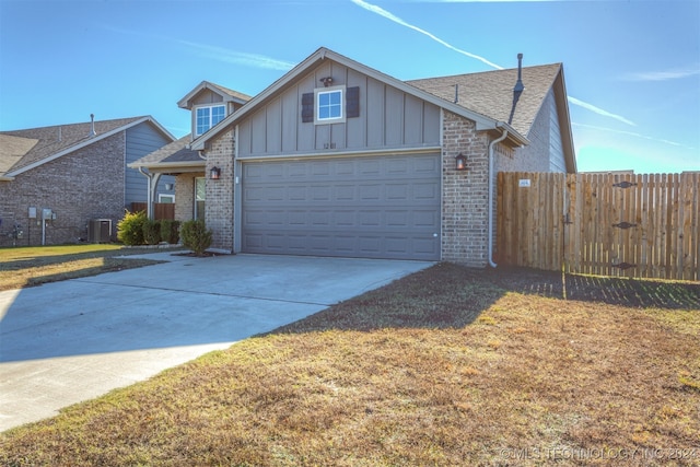 view of front facade featuring cooling unit and a front lawn