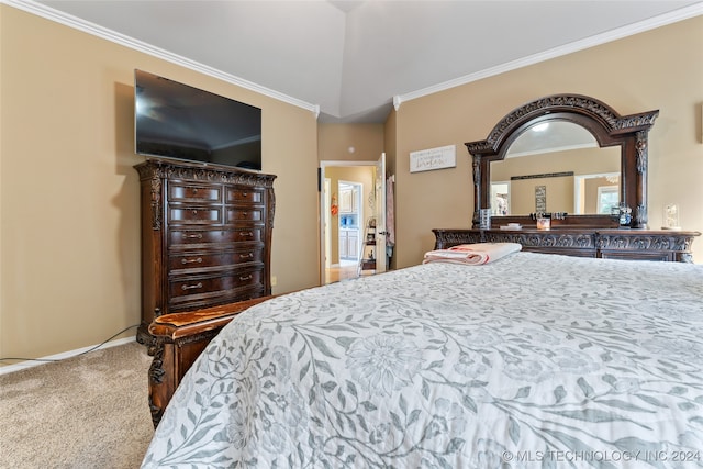 carpeted bedroom with vaulted ceiling and ornamental molding