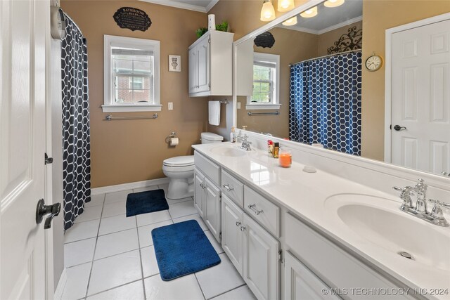 bathroom with tile patterned flooring, vanity, toilet, and crown molding