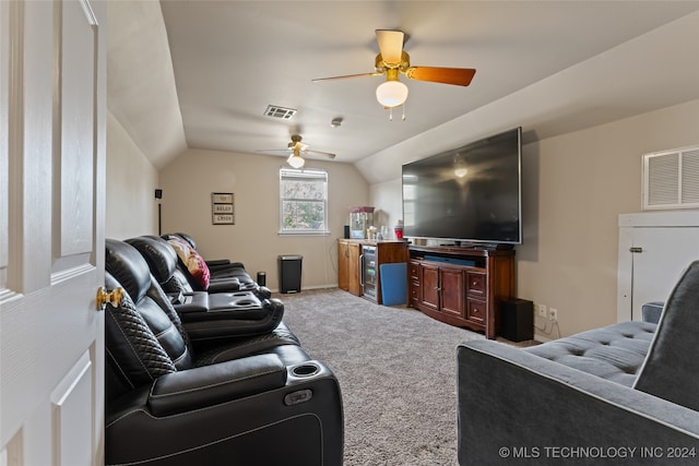 carpeted living room with ceiling fan and lofted ceiling