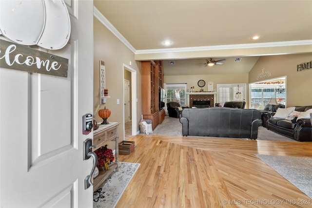 living room with hardwood / wood-style flooring, ceiling fan, lofted ceiling, and a wealth of natural light