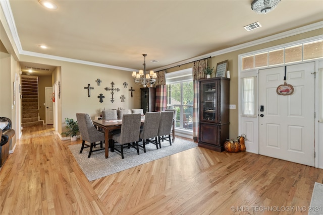 dining area with light hardwood / wood-style floors and crown molding