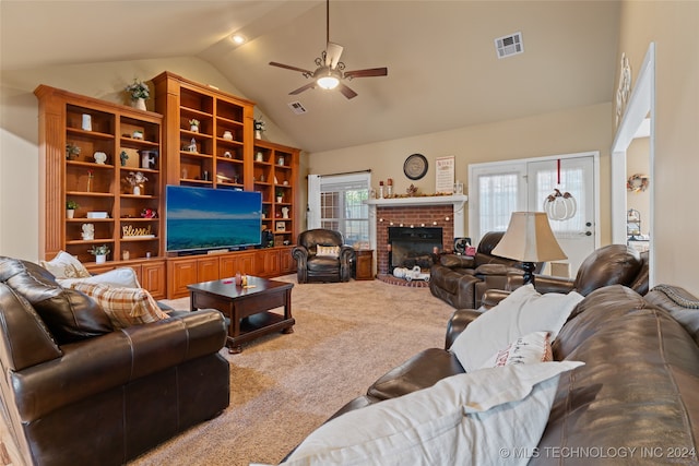 living room with ceiling fan, carpet floors, high vaulted ceiling, and a brick fireplace