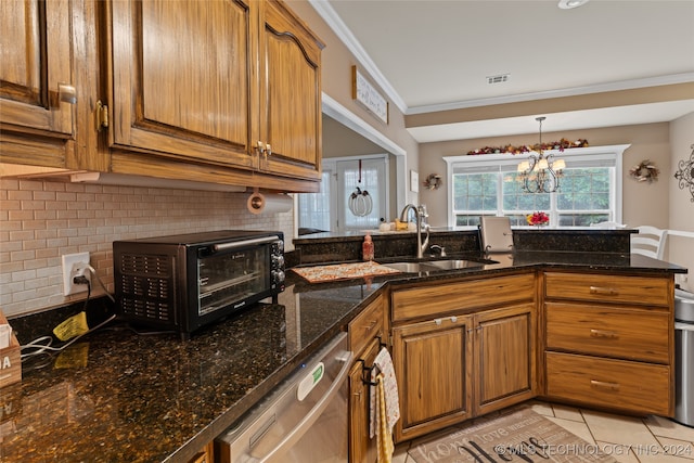 kitchen featuring sink, an inviting chandelier, stainless steel dishwasher, crown molding, and dark stone counters