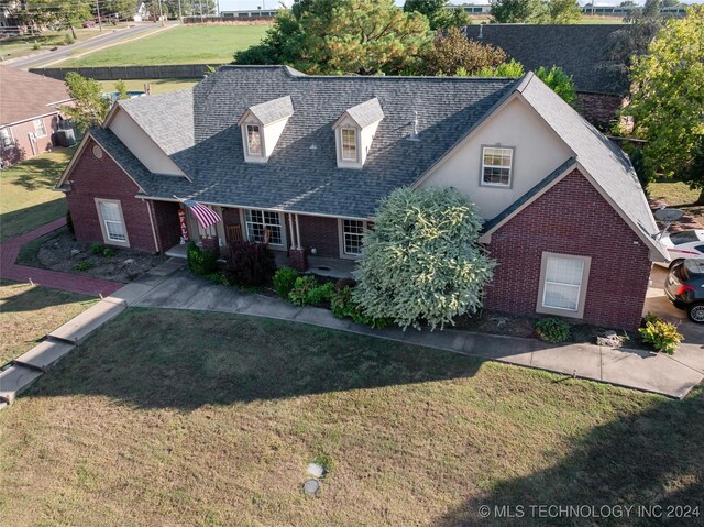 3103 Callaway Dr, Claremore, OK 74019 - view of front facade with brick siding, a shingled roof, a front yard, and stucco siding