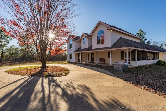 view of side of home with a porch