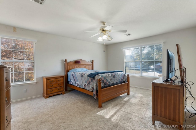 bedroom with ceiling fan and light colored carpet