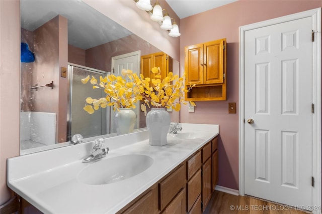 bathroom featuring hardwood / wood-style floors, vanity, and an enclosed shower