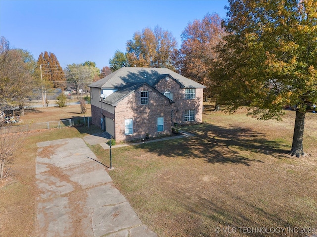 view of side of home featuring a yard and a garage