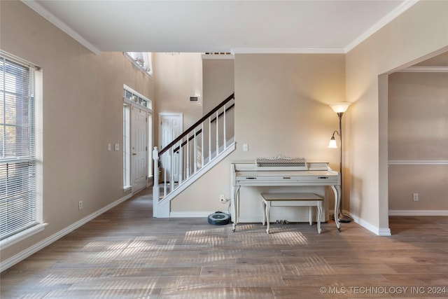 entryway featuring hardwood / wood-style flooring and crown molding