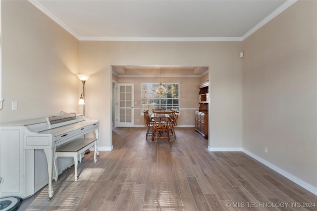 interior space featuring a chandelier, hardwood / wood-style flooring, and crown molding