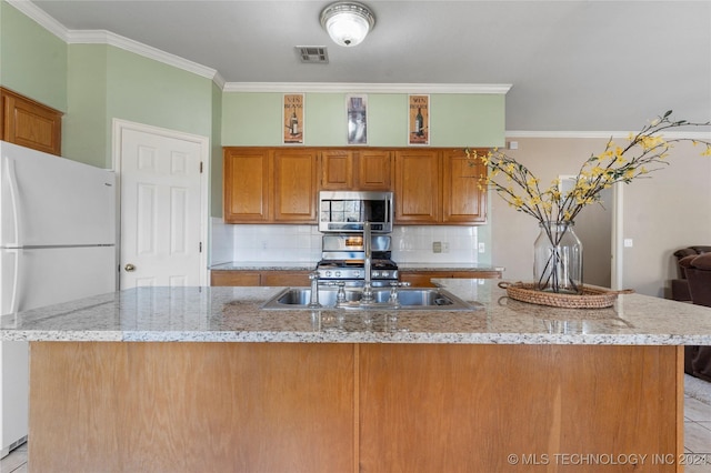 kitchen featuring white refrigerator, light stone countertops, and ornamental molding