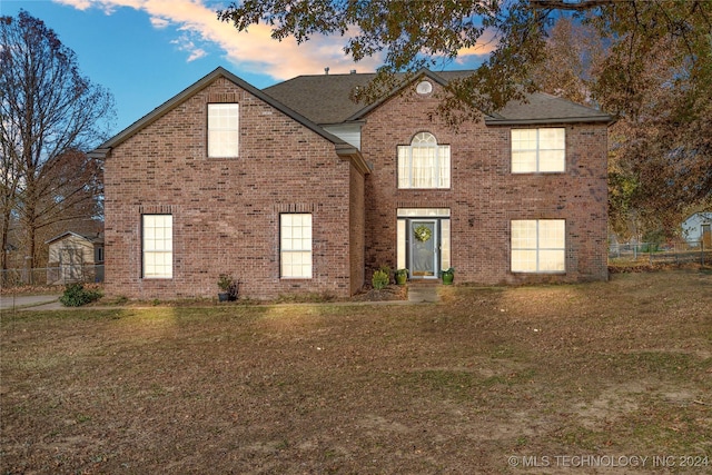 view of property featuring a lawn